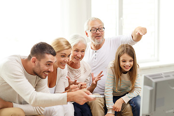 Image showing happy family watching tv at home