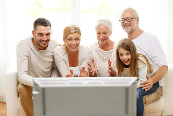 Image showing happy family watching tv at home