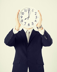 Image showing man with wall clock