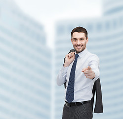 Image showing handsome buisnessman with jacket over shoulder