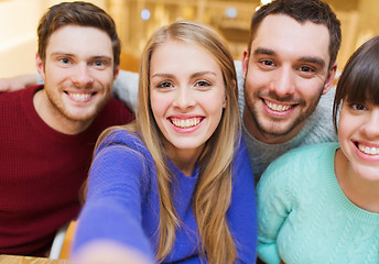 Image showing group of smiling friends taking selfie