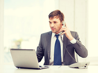 Image showing businessman with laptop computer and phone