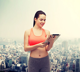 Image showing sporty woman with tablet pc computer