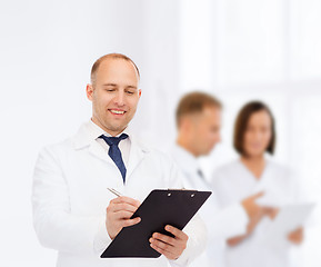 Image showing smiling male doctor with clipboard