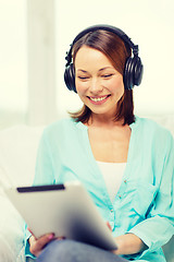 Image showing smiling woman with tablet pc and headphones