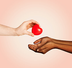 Image showing woman and man hands with red heart