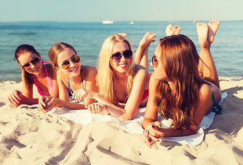 Image showing group of smiling women in sunglasses on beach