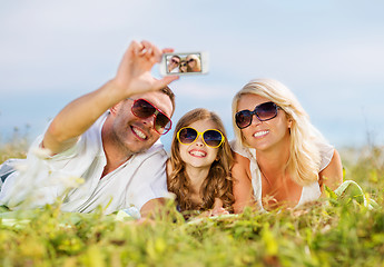 Image showing happy family with camera taking picture