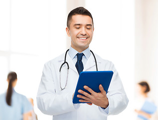 Image showing smiling male doctor with tablet pc at hospital