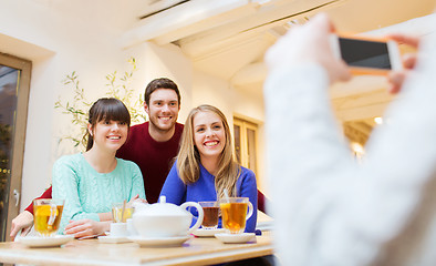 Image showing group of friends taking picture with smartphone