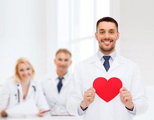 Image showing smiling male doctor with red heart