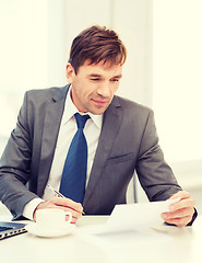 Image showing businessman with laptop computer and documents