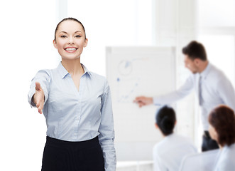 Image showing businesswoman with opened hand ready for handshake