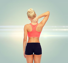 Image showing sporty woman touching her neck