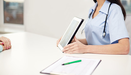 Image showing close up of doctor showing x-ray on tablet pc