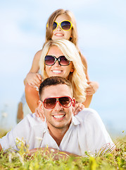 Image showing happy family with blue sky and green grass