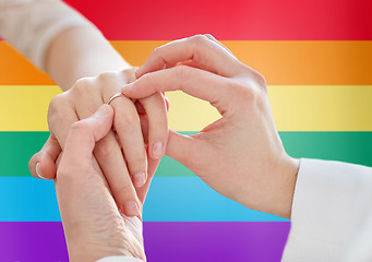 Image showing close up of lesbian couple hands with wedding ring