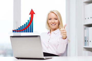 Image showing happy businesswoman with laptop showing thumbs up