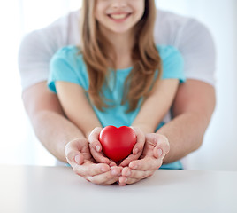 Image showing close up of man and girl holding red heart shape