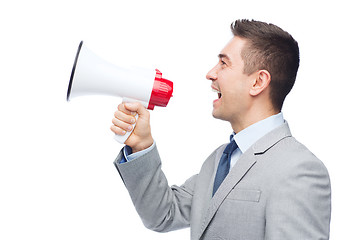 Image showing happy businessman in suit speaking to megaphone