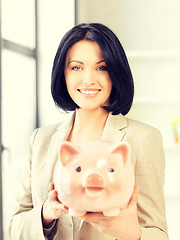 Image showing lovely woman with piggy bank