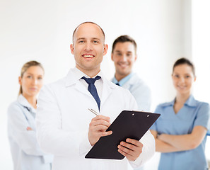 Image showing smiling male doctor with clipboard