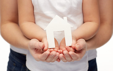 Image showing close up of woman and girl hands with paper house