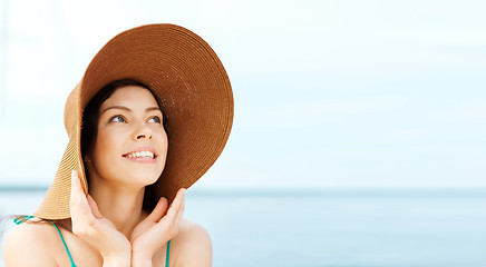 Image showing girl in hat standing on the beach