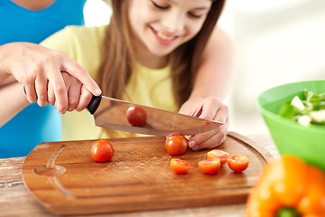 Image showing close up of happy family making dinner in kitchen