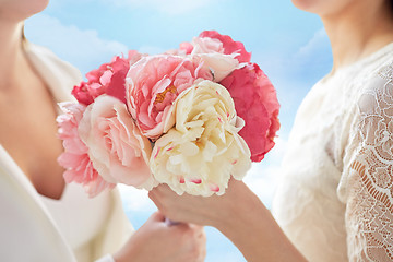 Image showing close up of happy lesbian couple with flowers