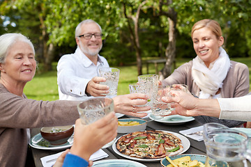 Image showing happy family having dinner in summer garden