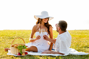 Image showing smiling couple drinking champagne on picnic