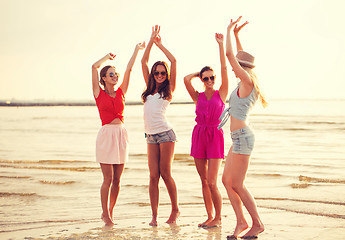 Image showing group of smiling women dancing on beach