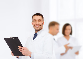 Image showing smiling male doctor with clipboard