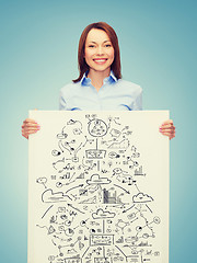 Image showing smiling businesswoman with plan in white board