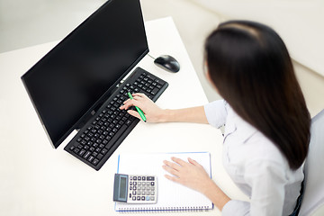 Image showing close up of woman with calculator counting