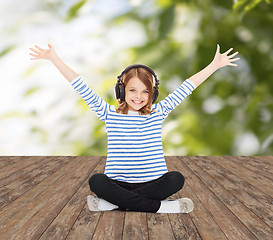 Image showing happy girl with headphones listening to music
