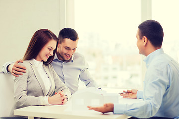 Image showing couple looking at model of their house at office