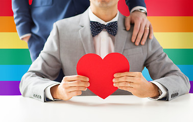 Image showing close up of male gay couple with red heart