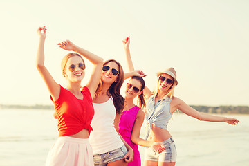 Image showing group of smiling women dancing on beach