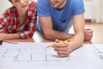 Image showing close up of couple with  blueprint at home