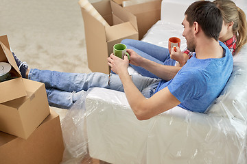 Image showing happy couple relaxing on sofa in new home