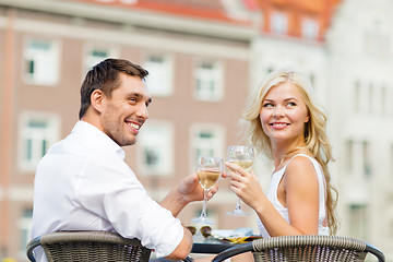 Image showing smiling couple drinking wine in cafe