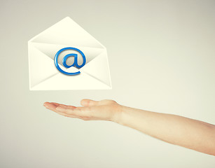 Image showing hand holding envelope with email sign