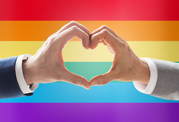 Image showing close up of male gay couple hands showing heart