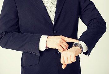 Image showing man looking at wristwatch