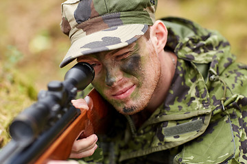 Image showing soldier or hunter shooting with gun in forest