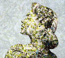 Image showing young woman face over blooming tree pattern