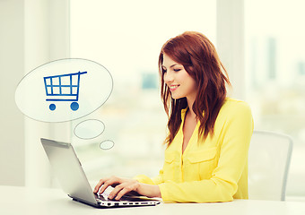 Image showing smiling woman with laptop computer shopping online