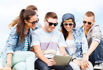 Image showing group of teenagers looking at tablet pc